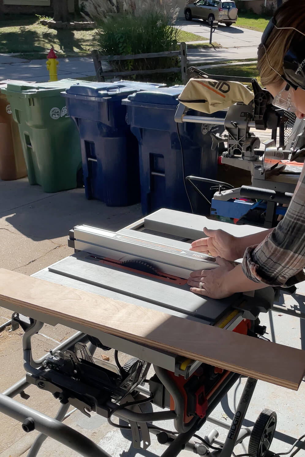 Adjusting the fence on the table saw. 